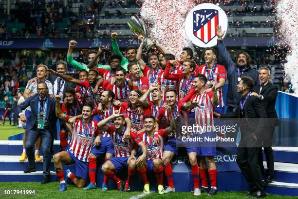 Atletico Madrid players and staff celebrate with the trophy after the UEFA Super Cup match between Real Madrid and Atletico Madrid on August 15, 2018...