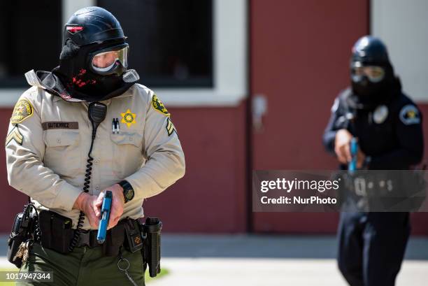 Los Angeles Sheriffs deputy and a police officer participate in an active shooter drill in a high school near Los Angeles, California on August 16,...