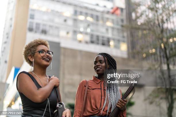 two students talking at street - hipster candid stock pictures, royalty-free photos & images