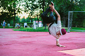 young hip hop street dancer in the city during the dusk doing freeze