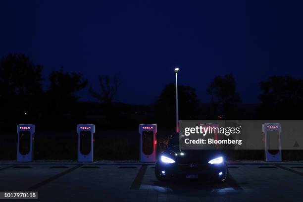 Tesla Inc. Model S electric vehicle charges at a Supercharger station at night in Rubigen, Switzerland, on Thursday, Aug. 16, 2018. Tesla chief...