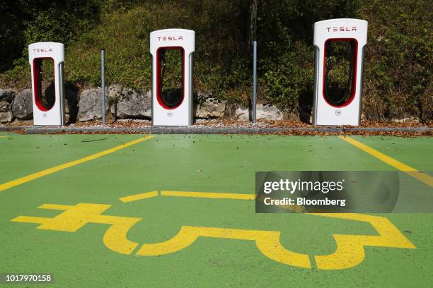 Parking bay marking displays an electric vehicle icon at a Supercharger station in Egerkingen, Switzerland, on Thursday, Aug. 16, 2018. Tesla chief...