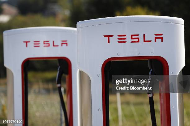 Tesla Inc. Supercharger stations stand in Rubigen, Switzerland, on Thursday, Aug. 16, 2018. Tesla chief executive officer Elon Musk has captivated...