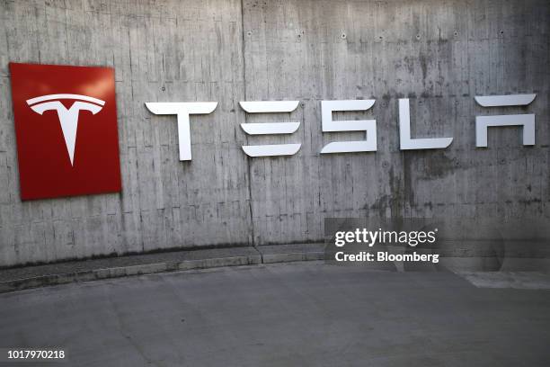 Company logo hangs outside a Tesla Inc. Store in Bern, Switzerland, on Thursday, Aug. 16, 2018. Tesla chief executive officer Elon Musk has...