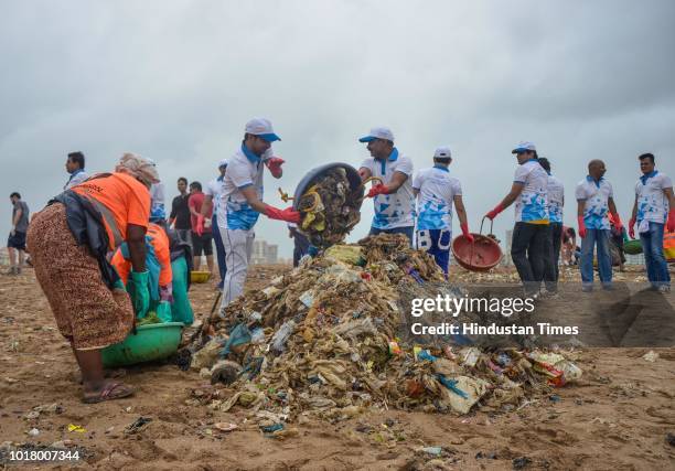 Local residents and volunteers participate during a beach cleanup campaign at Versova, on August 15, 2018 in Mumbai, India.