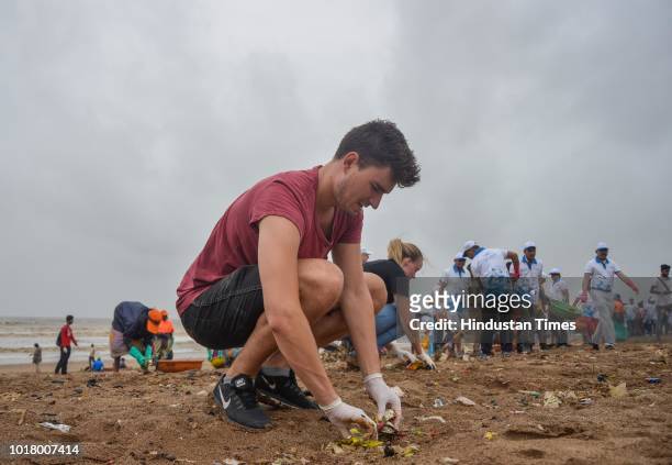 Local residents and volunteers participate during a beach cleanup campaign at Versova, on August 15, 2018 in Mumbai, India.