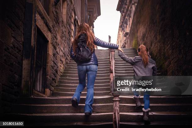 mother and daughter walking up steps in edinburgh, scotland - edinburgh scotland stock pictures, royalty-free photos & images