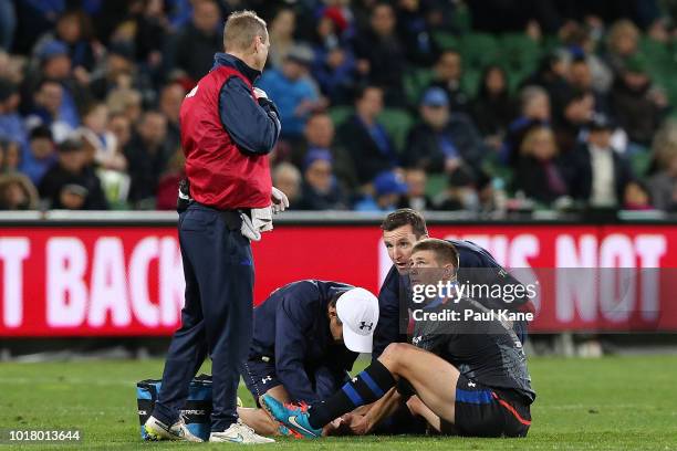 Berrick Barnes of the Wild Knights looks on while holding his right lower leg during the World Series Rugby match between the Force and Wild Knights...