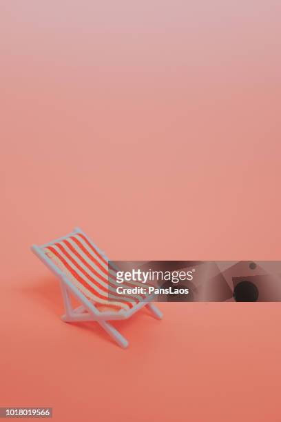 beach chair isolated on orange background - liegestuhl freisteller stock-fotos und bilder