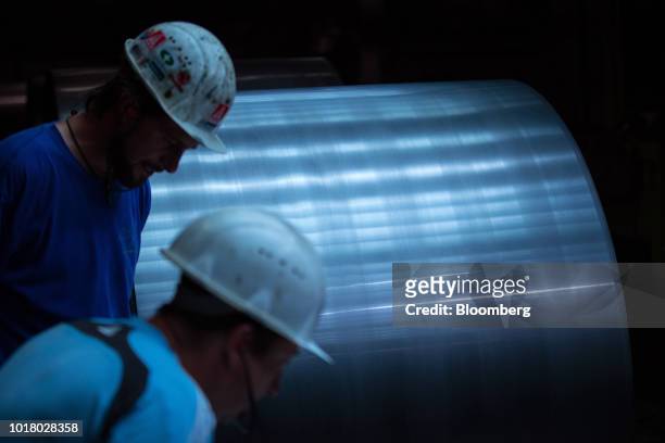 Employees inspect steel coils on the cold rolling line at the Thyssenkrupp Rasselstein GmbH steel packaging factory in Andernach, Germany, on...