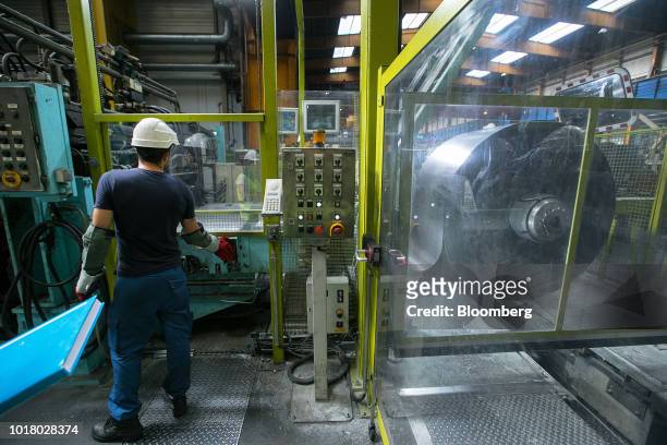 An employee loads a coil of strip steel for cleaning at the Thyssenkrupp Rasselstein GmbH steel packaging factory in Andernach, Germany, on Thursday,...