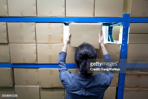 woman doing the inventory at a warehouse - building shelves stock pictures, royalty-free photos & images