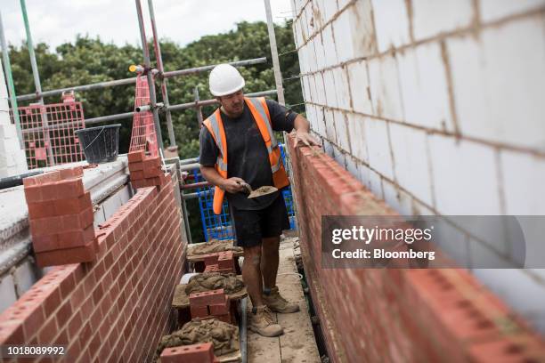 Bricklayer builds a wall at a Persimmon Plc residential construction site in Grays, U.K., on Tuesday, Aug. 14, 2018. Persimmon are due to report...