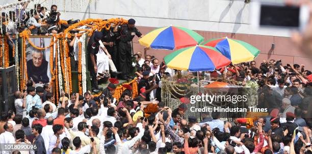 Prime minister Narendra Modi along with followers of Atal Bihari Vajpayee's take part in the funeral procession from the BJP headquarters, on August...