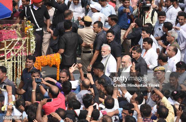 Prime Minister Narendra Modi and BJP President Amit Shah take part in the funeral procession of former Prime Minister Atal Bihari Vajpayee at ITO...