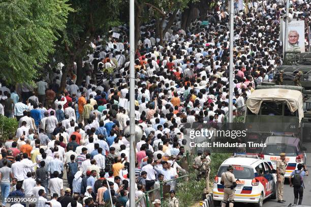 Followers of former Prime Minister Atal Bihari Vajpayee take part in his funeral procession along at DDU Marg on August 17, 2018 in New Delhi, India....