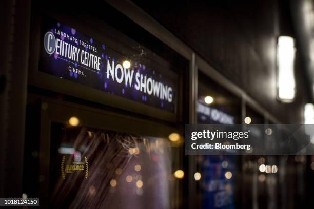 Signage is seen above a movie poster displayed outside of the Landmark Century Centre Cinema in Chicago, Illinois, U.S., on Thursday, Aug. 16, 2018....