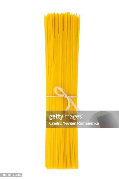 bunch of spaghetti isolated on white background - spaghetti foto e immagini stock