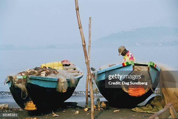 man in fishing boat, cameroon, africa - cameroon water stock pictures, royalty-free photos & images