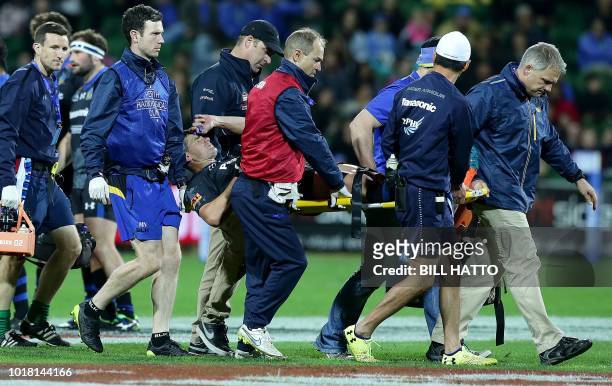 Berrick Barnes of Japan's Wild Knights is stretchered off the field after sustaining an injury during their World Series rugby match in Perth on...