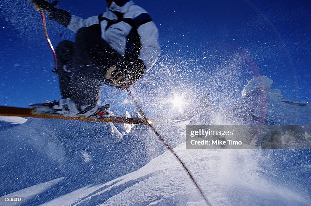 MALE SKIER JUMPING DOWN ICE BLOCK