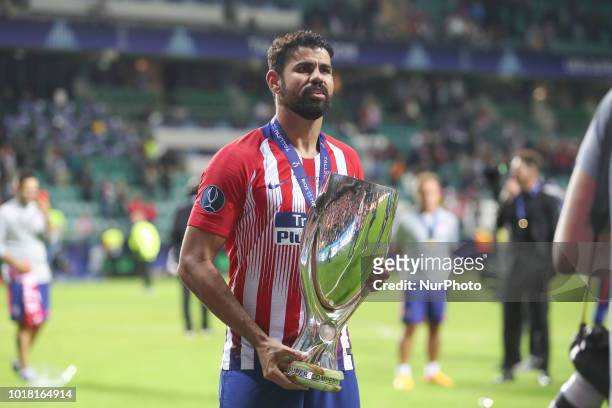 Diego Costa of Atletico Madrid celebrates with the trophy following the UEFA Super Cup between Real Madrid and Atletico Madrid at Lillekula Stadium...