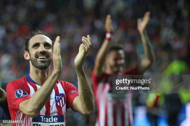 Atletico Madrid's Spanish defender Juanfran celebrates the victory at the end of the UEFA Super Cup football match between Real Madrid and Atletico...