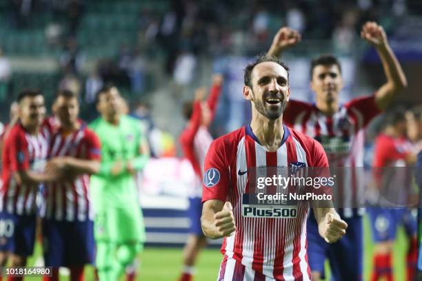 Atletico Madrid's Spanish defender Juanfran celebrates the victory at the end of the UEFA Super Cup football match between Real Madrid and Atletico...