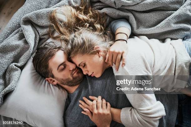 love makes for the sweetest of dreams - romantic young couple sleeping in bed stock pictures, royalty-free photos & images