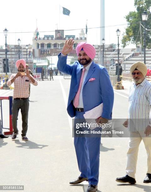 Former Cricketer And Punjab Local Bodies Minister Navjot Singh Sidhu bids goodbye as he crosses over to Pakistan at Attari-Wagah Border on August 17,...