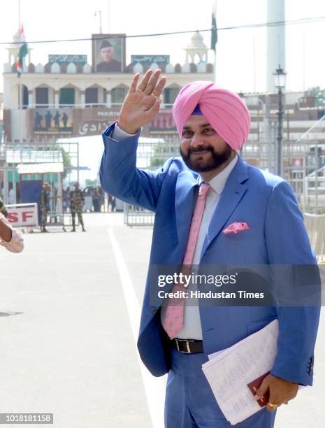 Former Cricketer And Punjab Local Bodies Minister Navjot Singh Sidhu bids goodbye as he crosses over to Pakistan at Attari-Wagah Border on August 17,...