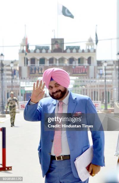 Former Cricketer And Punjab Local Bodies Minister Navjot Singh Sidhu bids goodbye as he crosses over to Pakistan at Attari-Wagah Border on August 17,...