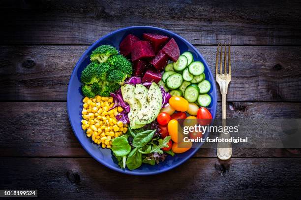 salad mix plate shot from above on rustic wooden table - vegetable plate stock pictures, royalty-free photos & images