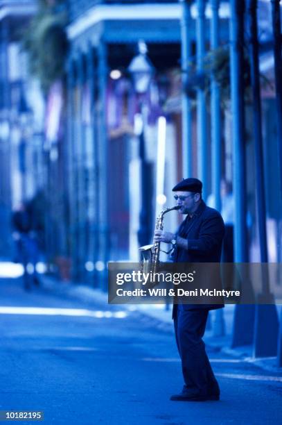 saxophone player on bourbon street - new orleans music stock pictures, royalty-free photos & images