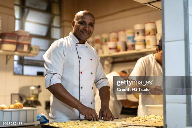 chef working at commercial kitchen - chef portrait stock pictures, royalty-free photos & images