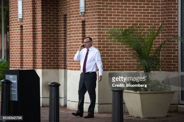 Brian Ketcham, lawyer for former Donald Trump Campaign Manager Paul Manafort, speaks on the mobile device across the street from District Court in...
