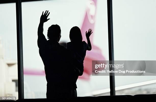 father & daughter waving to airplanes - closing gap stock pictures, royalty-free photos & images