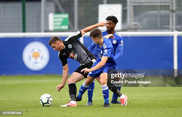 Khanya Lashabela and Connor Tee of Leicester City in action with Tyler Frost of Reading during the Premier League International Cup tie between...