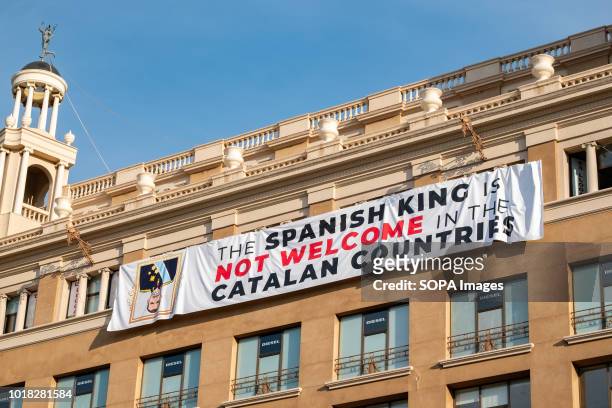 Large banner that rejects the visit of King Felipe VI is seen hanging on one of the buildings of Plaza Cataluna. Barcelona celebrated the first...