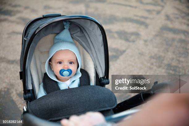 baby boy in a stroller - baby accessories the dummy stock pictures, royalty-free photos & images