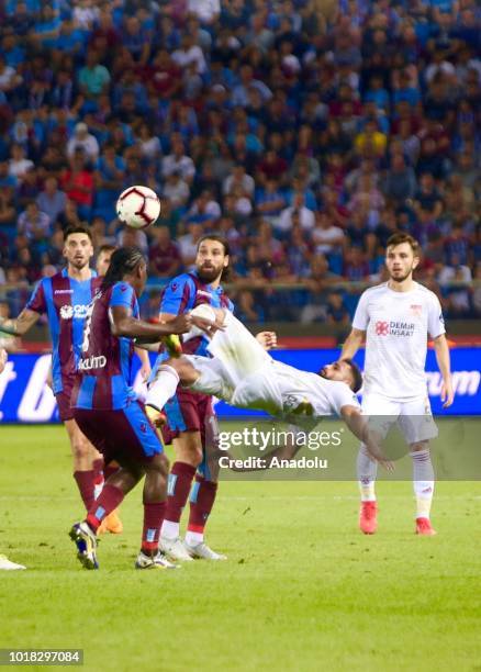 Douglas Pereira of Demir Grup Sivasspor in action against Hugo Rodallega and Olcay Sahan of Trabzonspor during the Turkish Super Lig soccer match...
