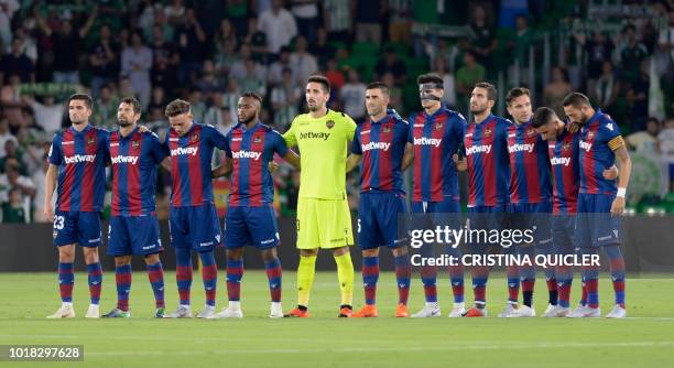 Levante players respect a minute of silence for the bridge disaster in Genova before the Spanish league football match between Real Betis and Levante...