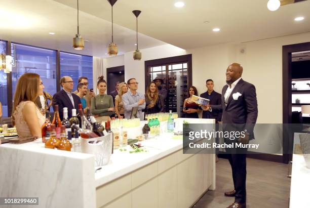 Kofi Nartey toasts with guests during The Nartey Group presents a Sellebrity Toast at Above the Penthouse in The W Residences on August 16, 2018 in...