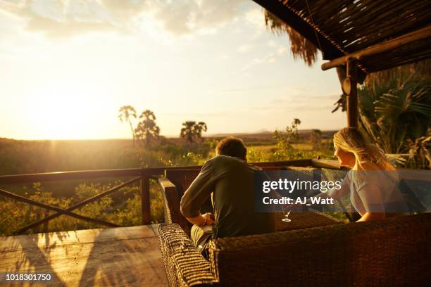 enjoying drinks and sunsets on our vacation - africa safari lodge stock pictures, royalty-free photos & images