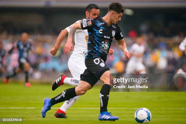 Angelo Sagal of Pachuca and Alan Mozo of Pumas fight for the ball during the fourth round match between Pumas UNAM and Pachuca as part of the Torneo...