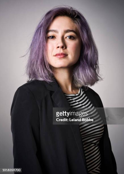 portrait of mixed race adult female with purple hair - purple hair stockfoto's en -beelden