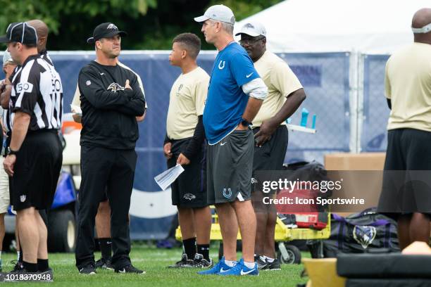 Baltimore Ravens head coach John Harbaugh talks to Indianapolis Colts head coach Frank Reich before the Indianapolis Colts joint training camp...