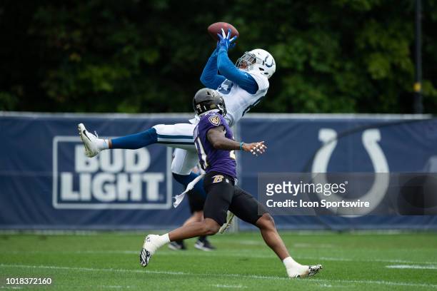 Indianapolis Colts tight end Eric Ebron catches a pass over Baltimore Ravens safety DeShon Elliott during the Indianapolis Colts joint training camp...