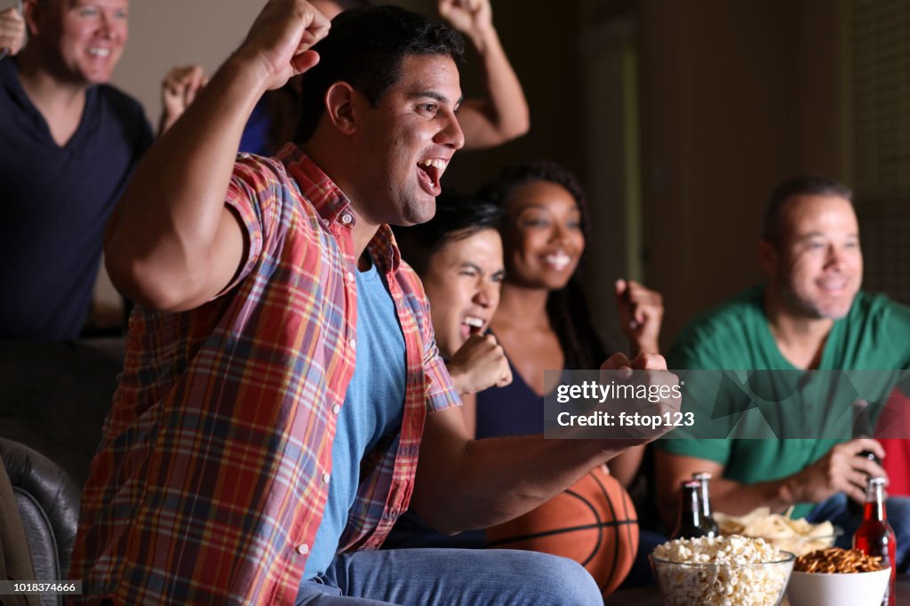 Basketball fans watching the game at home on television.