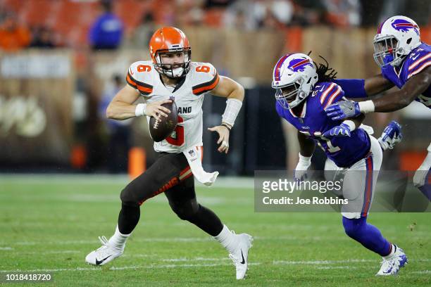 Baker Mayfield of the Cleveland Browns looks to pass while pursued by Julian Stanford of the Buffalo Bills in the third quarter of a preseason game...